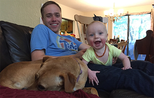 dog and baby on couch